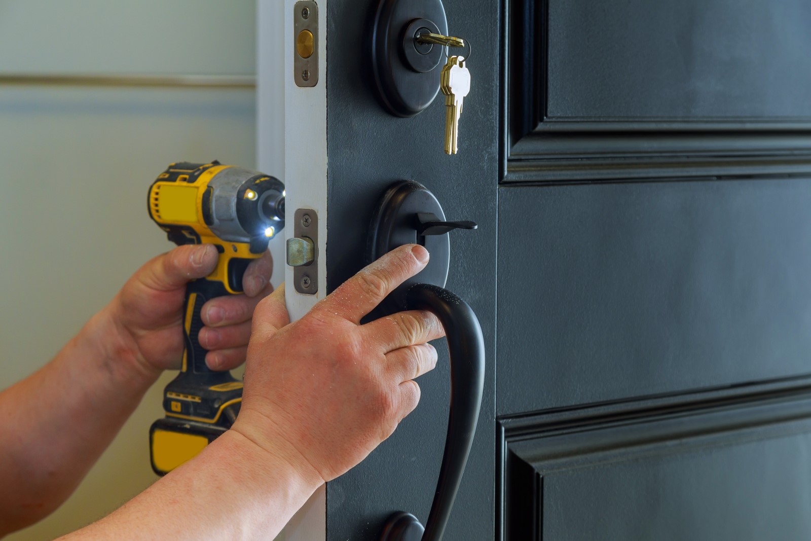 Locksmith installing a new deadbolt on a residential front door — typical Tampa Bay service call.